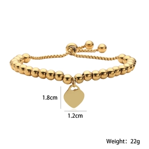 Detail showing 1.8cm heart pendant dimensions on a 4mm gold beaded adjustable bracelet