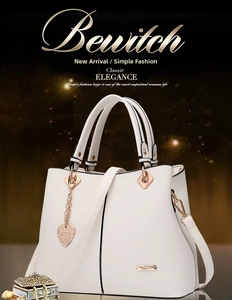 Close-up of white PU leather handbag with rose gold hardware and heart charm detail
