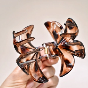 Detailed view of the large petal hair claw clip with vintage leopard print and metal spring