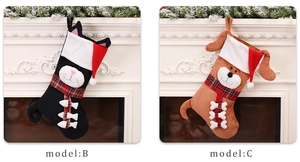 Close-up of cute cartoon cat and dog Christmas stockings on a white fireplace