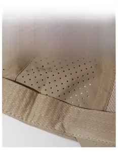 Macro detail of breathable perforated fabric and wide sweatband on khaki sports cap