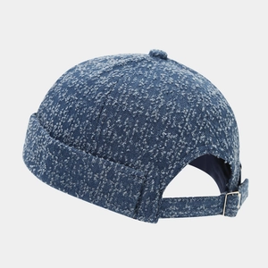 Detail of vintage denim docker cap with adjustable strap and metal buckle