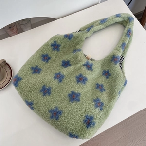 Close-up of plush tote bag with flower pattern, checkered lining and magnetic closure
