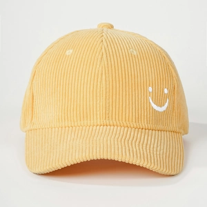 Detailed close-up showing the corduroy texture and white smiley face embroidery on the cap