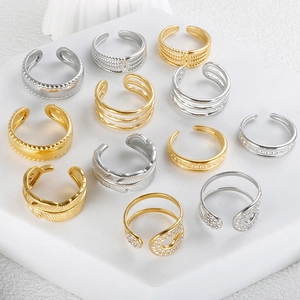 Collection of various gold and silver V-shaped rings with crystal and feather details