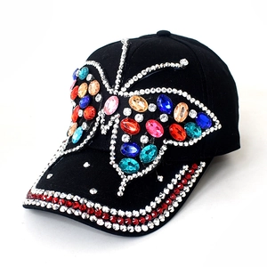 Detailed macro view of vibrant colorful rhinestone butterfly patterns on a black denim cap