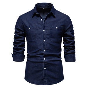 Detail of deep blue denim shirt featuring classic double pockets and white buttons