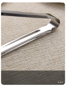Close-up of long-handle stainless steel food tongs with a mirror-polished finish