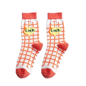 Japanese style white mid-calf socks with orange grid pattern and cartoon text design
