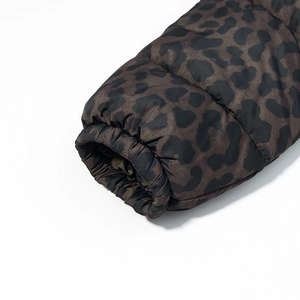 Detailed close-up of elastic leopard print cuffs on a warm puffer jacket for women