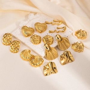 Detailed view of various vintage gold geometric heart and fan-shaped earrings set