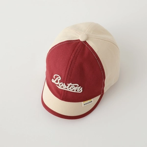 Close-up of Boston embroidery on two-tone red and beige cotton baseball cap for kids