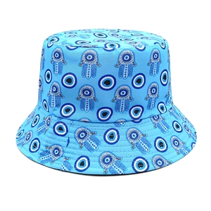 Close-up of light blue bucket hat featuring Evil Eye and Hamsa hand embroidery patterns