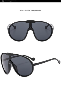 Detail view of large shield sunglasses with black frame, gray lenses, and metal hinge detail