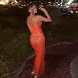 Detail of orange lace maxi dress with sheer mesh cutouts and slim fit back design