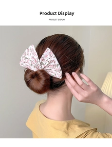 Floral print bow hair bun maker showing actual usage on a dark brown bun hairstyle