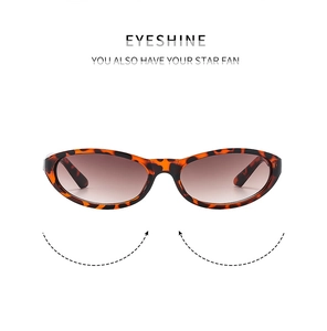 Detail of leopard print oval sunglasses with gradient brown lenses on white background