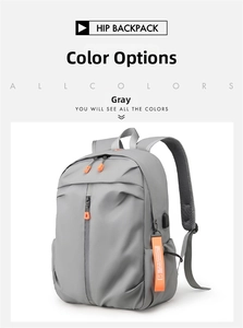 Detail view of large grey laptop backpack featuring USB port and orange zipper accents