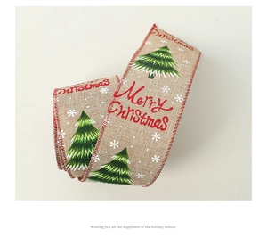 Detailed texture of burlap Christmas ribbon with green trees and red Merry Christmas text
