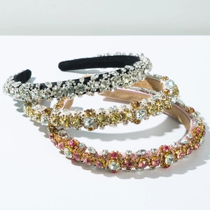 Detailed view of luxury baroque headbands featuring sparkling rhinestones and velvet texture