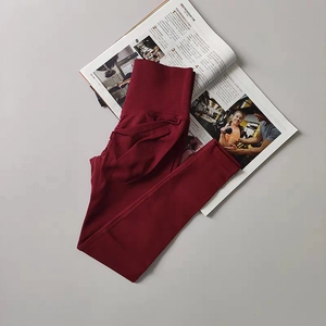 Detail view of high-waisted burgundy yoga pants with scrunch butt lifting design