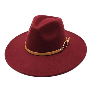 Detail of burgundy wool fedora with broad brim and leather band with gold buckle