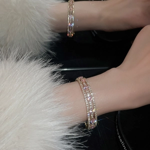 Detail of rose gold multi-layer bracelet with sparkling pink and clear cubic zirconia