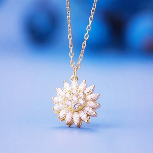 Elegant rotating sunflower necklace in gold finish with micro-set zircon crystals