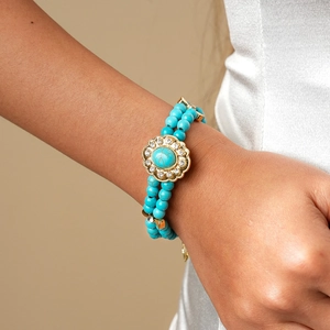 Close-up of double-layer turquoise beaded necklace with floral crystal pendant