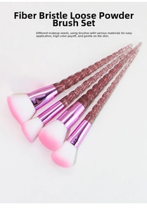 Close-up of makeup brushes with unicorn spiral handles and soft fiber gradient bristles
