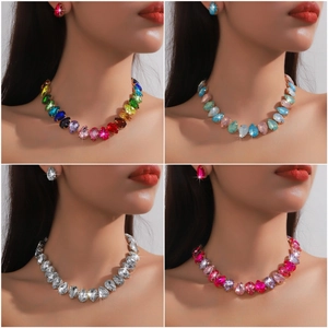 Multi-colored pear-cut crystal necklace and earring set in vibrant geometric styles