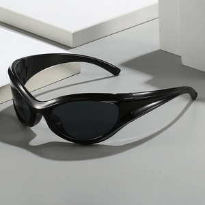 Y2K style black wrap-around sports sunglasses with streamlined frame on grey surface