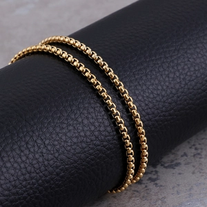 Close-up of double-layered gold-plated stainless steel round chain necklace on display
