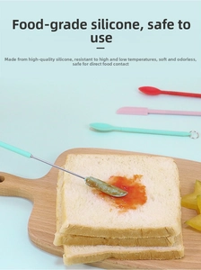 Close-up of food-grade silicone mini spatulas spreading jam on toast in a kitchen setting