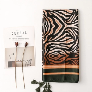 Close-up of zebra pattern scarf with tassels and smooth texture on flat layout