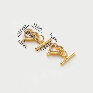 Detail view of 14k gold-plated heart-shaped OT toggle clasp with rhinestone inlay for jewelry