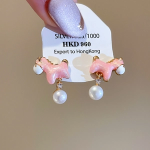 Detail of pink enamel pony earring with pearl drop and S925 silver needle on a card