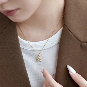 Detailed view of a gold-plated silver necklace featuring a sparkling full-diamond bear pendant