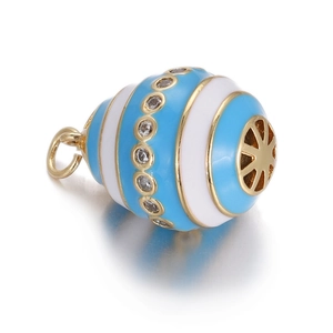 Macro detail of blue and white enamel Faberge style evil eye pendant with gold accents