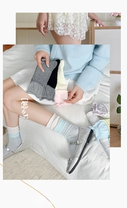 Detailed macro view of assorted pastel mid-calf socks with ribbed bubble cuffs