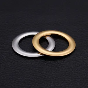 Interlocked gold and silver stainless steel rings on a black leather background