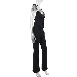 Detail view of black cowl neck jumpsuit featuring a deep V-neckline and flared leg silhouette