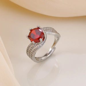 Close-up of adjustable silver ring with a large red zircon and pavé crystal bands
