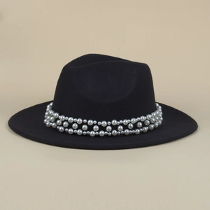 Detailed view of white faux pearls on the black wool fedora hat with elegant texture