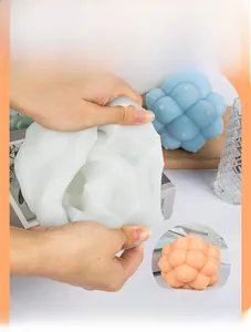 Detail showing the flexibility of a silicone mold with spherical textures for DIY candles