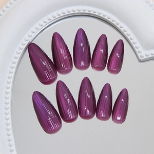 Deep purple cat eye press on nails in stiletto shape with magnetic glitter effect