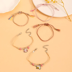 Detail of five-piece Bohemian woven friendship bracelets with tassels and charms