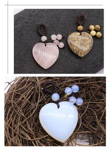 Macro detail of heart-shaped gemstone pendants with woven rope and decorative beads
