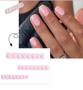 Close-up of light pink glossy press-on nails with short square shape and jelly texture