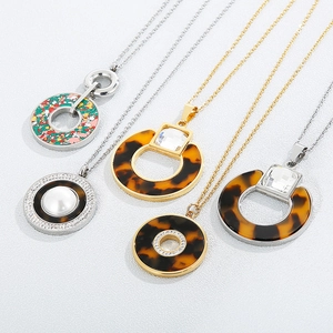 Retro stainless steel necklaces with crystal pendants and resin details on a white background